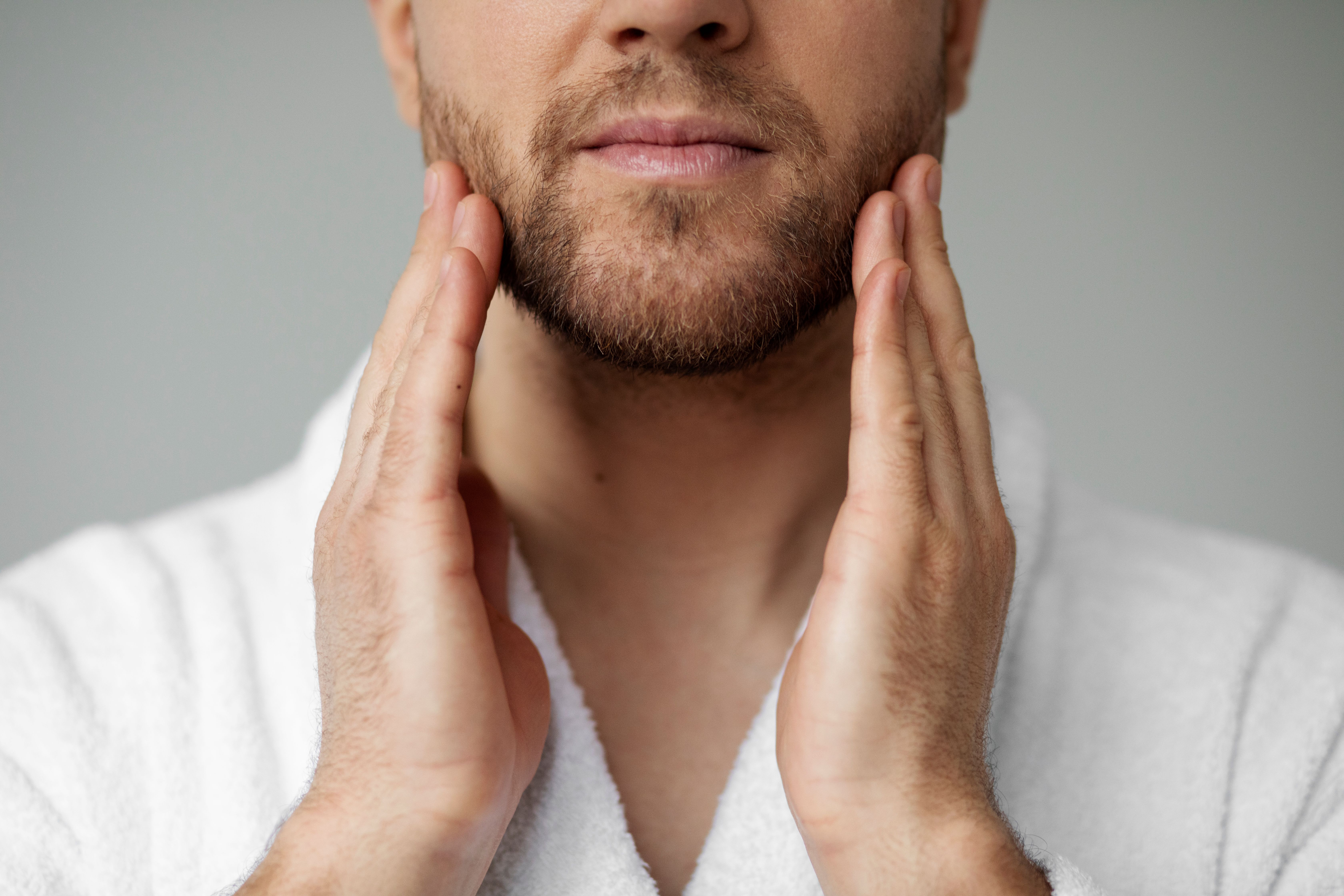 young-man-applying-his-anti-aging-treatment.jpg